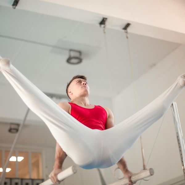 Man performing a core strength exercise in a focused environment.